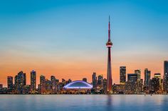 the skyline of toronto, canada at sunset with the words winny on it in red