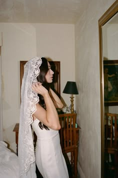 This mantilla embodies poetic romance. Crafted from ethereal floral-embroidered lace, it cascades with the grace of a love sonnet, delicately framed by French alencon lace. With its vintage-inspired design, it is a love story spun in lace, destined to drape over your head with grace. • A classic 42'' fingertip length bridal veil that is hand sewn from the most luxurious all-over floral embroidery• The edge of the veil is trimmed with a customizable scalloped lace• In white, off white, light ivor Poetic Romance, Mantilla Wedding Veil, Mantilla Veil Wedding, Elbow Length Veil, Fingertip Wedding Veils, Lace Mantilla, 사진 촬영 포즈, Alencon Lace, Dream Wedding Ideas Dresses