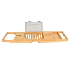 a bamboo tray with two compartments and a glass on top