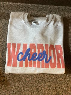 a t - shirt with the word cheer on it sitting on a granite counter top