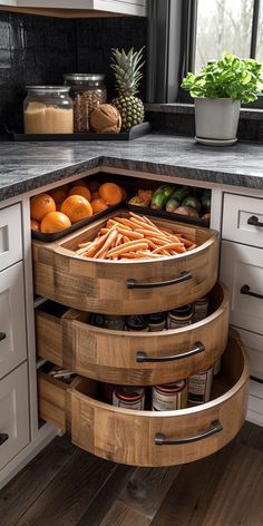 an open drawer in the middle of a kitchen with fruit and vegetables on it's sides