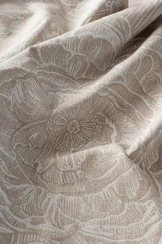 a close up view of the fabric on a bed