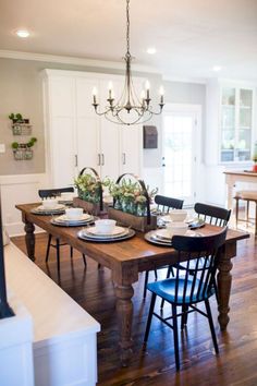 a dining room table with plates and bowls on it