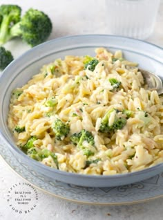 a bowl filled with pasta and broccoli on top of a table