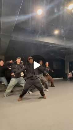 a group of young men standing on top of a dance floor