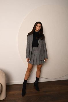 Make a stylish statement with this Grey Blazer and Pleated Skirt Set, a perfect combination of structured elegance and playful charm. The tailored grey blazer features a classic single-button closure, providing a sleek and refined silhouette. With its notched lapels and clean lines, this blazer adds a polished touch to any outfit. The versatile grey color makes it an easy piece to mix and match, perfect for layering over turtlenecks, blouses, or t-shirts for a chic, office-ready look or a casual Grey Blazer With Dress, Blazer And Pleated Skirt, Blazer With Dress, Ensemble Blazer, Pleated Skirt Set, Elegant Suit, Blazer And Skirt Set, Elegant Blazers, Stylish Suit