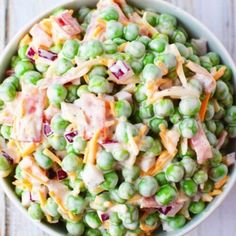 a white bowl filled with peas and ham salad