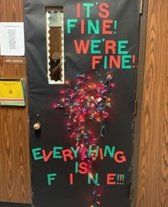 a door decorated with lights and writing that says it's fine we're fine everything is fine