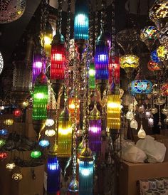 many different colored lights hanging from the ceiling