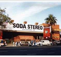 people are walking in front of the soda store