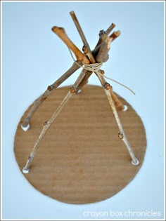 a paper plate with sticks sticking out of it