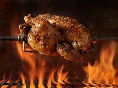 a cooked chicken sitting on top of a grill