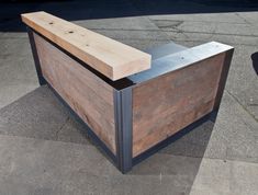 a wooden counter sitting on top of a sidewalk