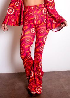 Say hello to your new favorite pants! Our Highwaist Bell Bottoms in Red Flowers are sure to be your go-to for those '70s-style grooves and disco nights! With their throwback style and fun pattern, you'll be turning heads in this retro pair of pants. Shake your groovy thing! This listing is for the pants ONLY. They are pictured with our matching Disco Ring Top. The pants are HIGH-WAISTED. The rise is approx 12". The inseam is 34.75", they are cut a little longer to wear with heels. They are made Retro Flares For Fall, Retro Fall Flares, 70s Inspired Stretch Pants For Fall, Retro Red Bottoms For Fall, Stretch 70s Inspired Fall Pants, Stretch Pants For Fall In 70s Style, Retro Style Fall Festival Pants, Fitted Wide Leg Pants With Retro Print, Retro Full-length Fall Flares