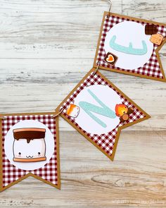 three cards with pictures of food and drink on them sitting on a wooden table next to each other