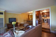 a living room filled with furniture and a flat screen tv