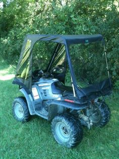 an off - road vehicle is parked in the grass