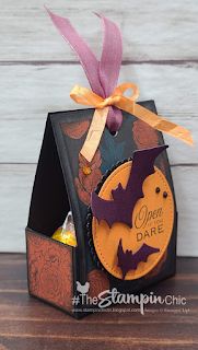 a small halloween treat box with bats on it