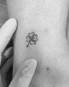 a small four leaf clover tattoo on the ankle