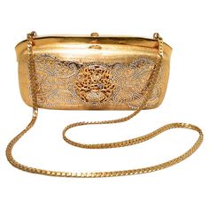 Stunning Judith Leiber Vintage gold box minaudiere in very good vintage condition. Gold structured box exterior trimmed with clear swarovski crystals and an attached gold chain shoulder strap. Top button closure opens to a gold leather lined interior that has two separate compartments. No stains, smells, or missing crystals. Light scuffs inside from use and age. This piece is perfect for any formal occasion as it coordinates with any wardrobe choice and will add the perfect amount of sparkle to Sparkly Purse, Judith Leiber Handbags, Judith Leiber Bags, Formal Clutch, Clear Handbags, Vintage Evening Bags, Crystal Box, Handbag Heaven, Gold Box