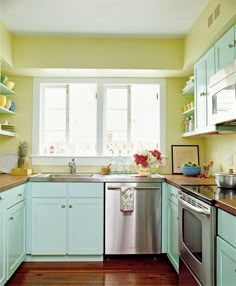 a kitchen with blue cabinets and stainless steel appliances, including a dishwasher in the center