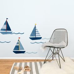 there are three sailboats painted on the wall in this child's playroom