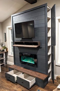 a living room with a fireplace and built - in entertainment center on the far wall