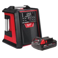 the milwaukee power tool is next to its charger and battery holder, which also includes a drill bit