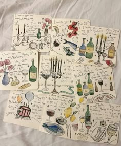 four handwritten notes with wine bottles and candles on them, all written in different languages