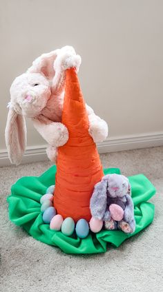 Image shows a crafted giant carrot upturned to be worn as a hat. There's a large bunny stuck on eating the carrot. Easter Dog