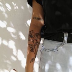 a person with a flower tattoo on their arm