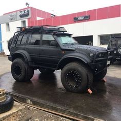 a black suv parked in front of a building