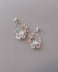 APPLE ORCHARD | Pastel Wedding Statement Earrings Our pretty new APPLE ORCHARD earrings easily inspire us with visions of secret gardens and garden style weddings Designed for the modern romantic bride with a flair for the whimsical and romantic at heart. These stunning hoop earrings are our newest creation of wearable art, botanical by design and dramatically detailed Golden hoops embellished with handcrafted and tinted clay flowers in tones of pastel pinks, blues and ivories all finished with Whimsical White Wedding Earrings, Whimsical Drop Earrings For Wedding, Whimsical Flower Earrings For Wedding, Pink Flower Hoop Earrings For Wedding, Wedding Statement Earrings, Statement Earrings Wedding, Wedding Hoop, Bridal Statement Earrings, Apple Orchard