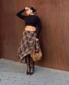 Channeling modern sophistication, this look combines a timeless plaid asymmetric skirt with a sleek black crop top and knee-high boots. The earthy tones and layered textures make it perfect for transitional seasons. #PlaidPerfection #EarthyElegance #FallFashion Styling Skirts For Winter, How To Style A Skirt In Winter, Nyc Dinner Outfit Winter, Fashion Killa Fall, Fall 24 Outfits, Fall Winter Outfits 2024, Fashionable Winter Outfits, Fashion Inspo Outfits Fall 2024, Summer Into Fall Outfits