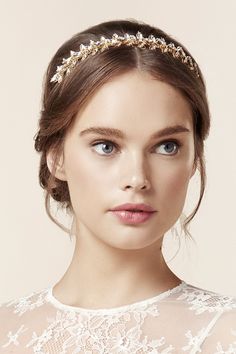 a woman wearing a gold headpiece with pearls on it's forehead and hair comb