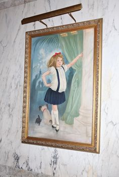 a painting on the wall of a room with a girl in school uniform pointing at something