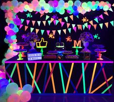 an image of a party with neon lights on the table and decorations in the background