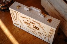 a wooden tool box sitting on top of a hard wood floor