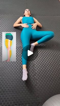 a woman laying on top of an exercise mat