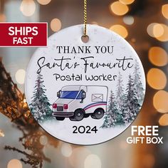 a personalized christmas ornament with a camper and trees in the background