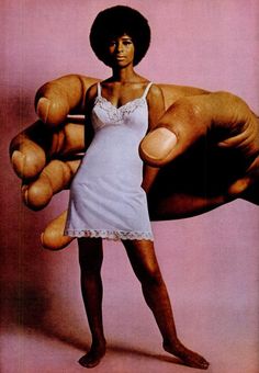 a woman in a white dress holding up a giant teddy bear with her right hand