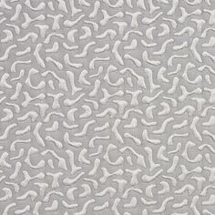 an upholstered fabric with white and grey designs on it's surface,