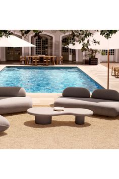 an outdoor lounge set next to a swimming pool