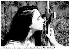 a woman with long hair is holding an object in her hand and looking at it