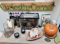 a table topped with lots of different types of items on top of a wooden sign