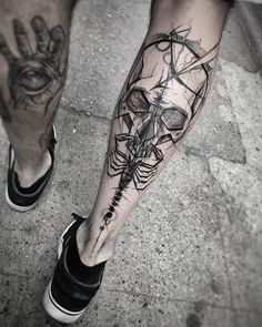 a man's leg with a black and white tattoo design on his left arm