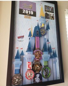 a framed photo of a castle with lots of watches on it's display case