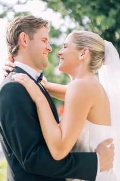 the bride and groom are embracing each other