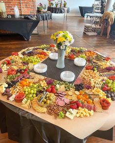 a table topped with lots of different types of food on top of a wooden floor