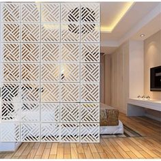 the room divider is made out of white plastic and has geometric designs on it